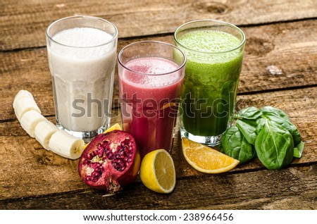 Healthy smoothie - banana-vanilla, pomegranate and orange, spinach and herbs