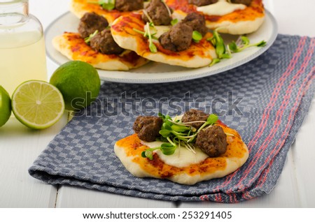 Mini pizza with meatballs, lime juice - fresh, microgreens on top, organic food, beef meat