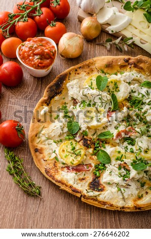 Pizza Bianco with Rosemary and Pancetta, with potatoes and creame cheese with garlic, sprinkled herbs and tomato