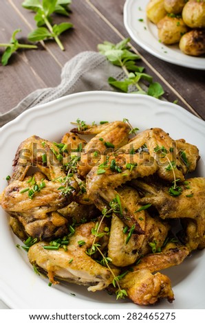 Roasted chicken wings with new potato - potato roasted in country  style