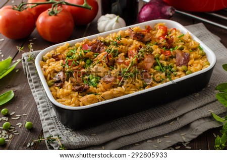 Cajun chicken with rice,  full of flavor and hot spices with fresh vegetable bio peas