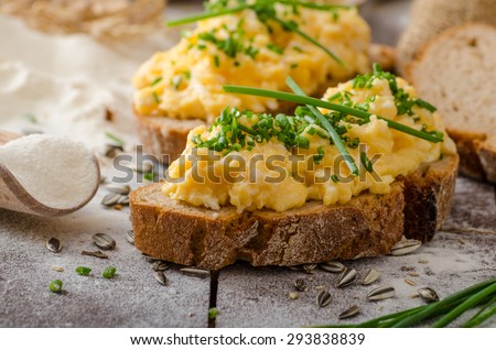 Scrambled eggs with herbs on wheat-rye crispy bread, homemade