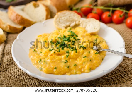 French style scrambled eggs with chives with french baquette and mini tomatoes