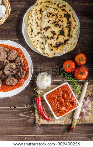 Indian lunch - meat balls with naan bread and spicy tomato sauce