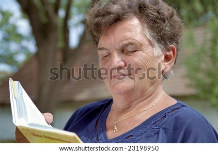 Old woman is reading a book