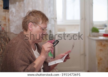 Correspondence received by mail. An elderly woman looks at the bill. A small pension in Russia and you need to save a person.