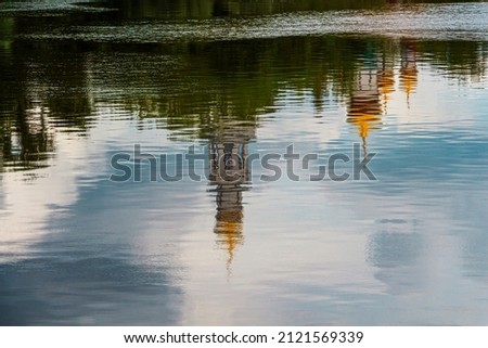 Similar – Image, Stock Photo Reflection of a church tower and houses in the water