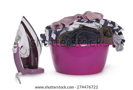 Basket of freshly laundered washing in basket with iron and clothes pegs