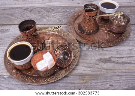 Copper set for making turkish coffee with spices, coffee is ready to be served.