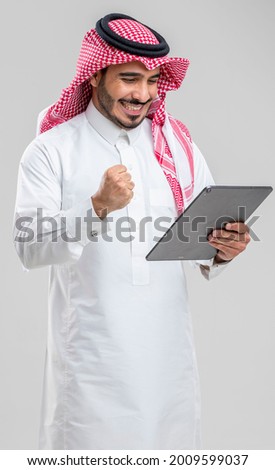 Saudi man holding a tablet