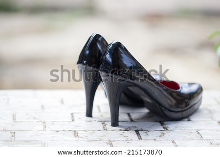 Close-up of female high-heeled shoes  on the marble floor