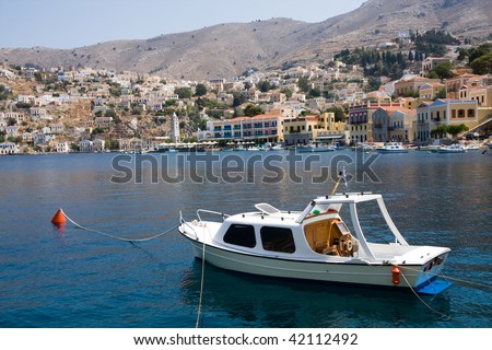 Small yacht and houses on symi island