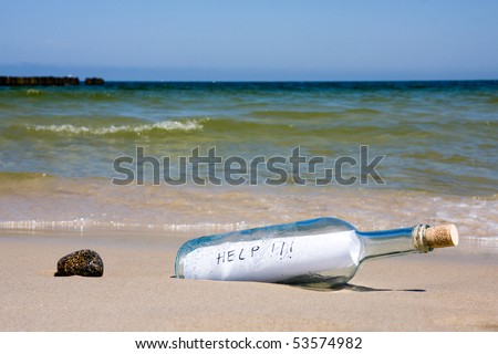 Help message in the bottle on a sea shore