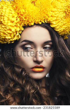 Beautiful young girl with a floral ornament in her hair
