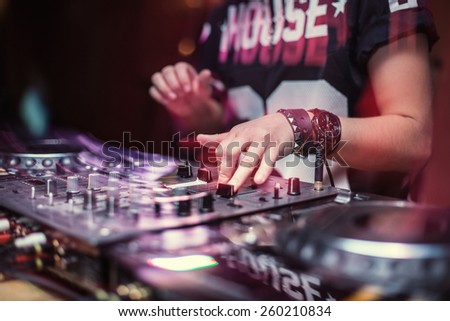 Dj playing disco house progressive electro music at the concert. DJ hands on equipment