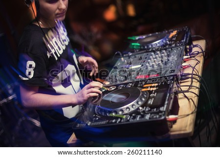 Dj playing disco house progressive electro music at the concert. DJ hands on equipment