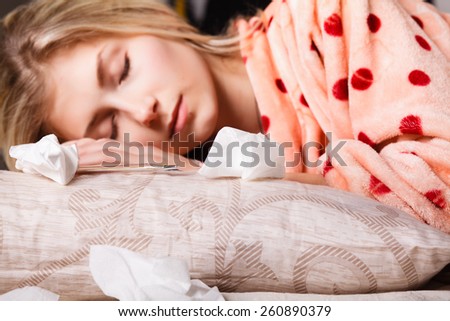 sick beautiful girl sleeping in the bed next to medicines, napkins and tablets. concept. girl sick in bed