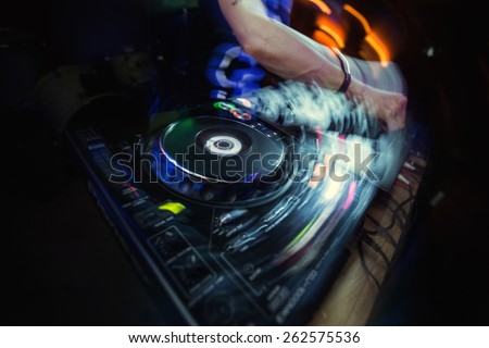 Dj playing disco house progressive electro music at the concert.\
 DJ hands on equipment