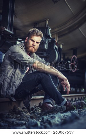 oung handsome attractive bearded model man in urban context