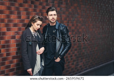 Outdoor lifestyle portrait of young couple in love standing in old town on the street