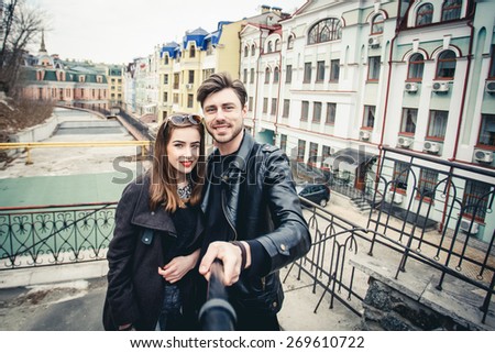 Outdoor lifestyle portrait of young couple in love standing in old town on the street