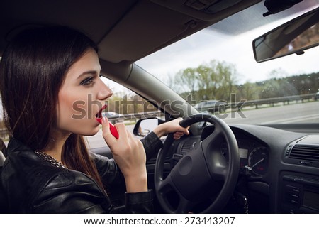 painted woman driving a car