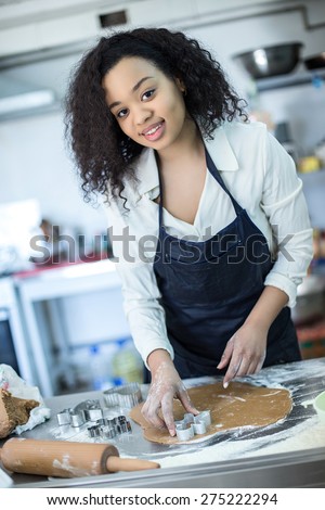 A young girl learns to cook cakes in the bakery