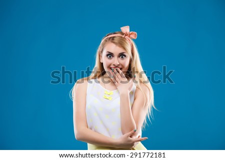 beautiful girl in the studio on a blue background in the style of pin-up, in a yellow dress, flirting, showing different emotions