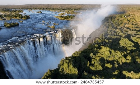 Similar – Image, Stock Photo Waterfall flowing into river in nature