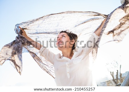 Free Happy Woman Enjoying Nature or Holiday. Beauty Girl Outdoor with Scarf. Freedom concept. Beauty Girl over Sky and Sun. Enjoyment.