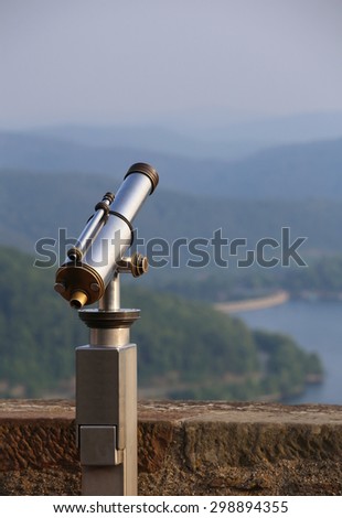 View over the mountains in Hesse, Germany, besides an old-fashioned telescope.