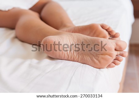 Two feet in a white bed