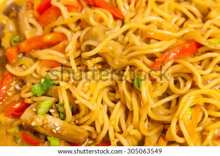 Asian egg noodles with vegetables, mushrooms, green onions and sesame