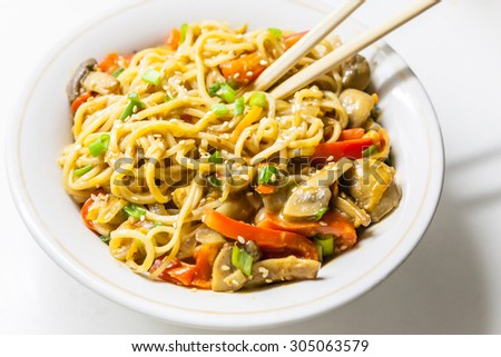 Asian egg noodles with vegetables, mushrooms, green onions and sesame