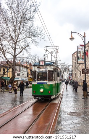 Bursa, Turkey - March 14: Green tram on the street on March 14, 2012 in Bursa, Turkey. Nostalgic tram is a short route going through historical districts of Bursa city.