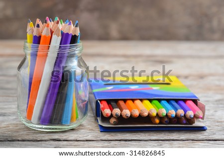 Pencil crayons in wood background
