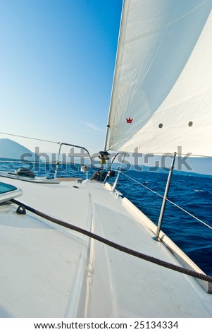 Front part of a sailboat, set on full sails in Ionian sea