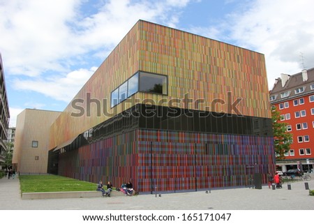 MUNICH - MAY 20: People sitting in front of the Brandhorst Art Collection and Exhibition building in Munich on May 20th, 2013.