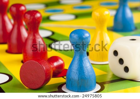 Colored board game figures with dice