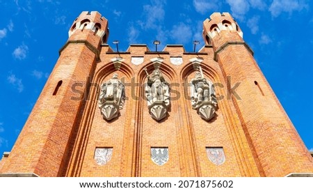 Bas-relief and coats of arms on the facade of the red brick King's Gate, Kaliningrad, Russia. Bas-reliefs of King Otakar II of Bohemia, King of Prussia Frederick I and Duke of Prussia Albrecht I. Stock fotó © 