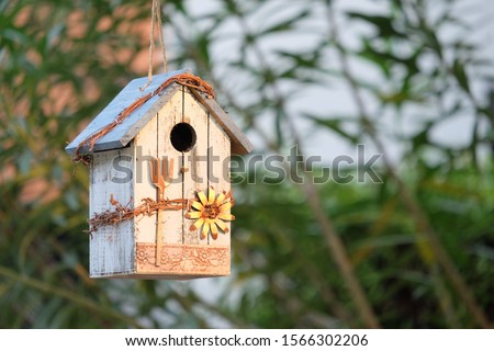 Similar – Foto Bild Am Baum hängendes Vogelhaus mit dem kreisförmigen Eingangsloch