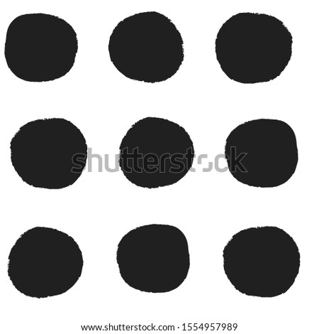 Seamless repeat pattern with big bold black irregular rough edge hand-drawn polka dots in rows on a white background