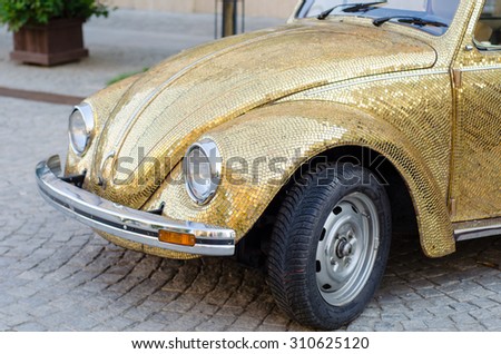 Beautiful retro glod covered car.