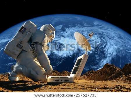Astronaut on his knees near the solar battery. \