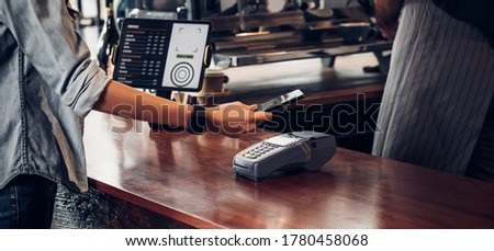 customer contactless payment for drink with mobile phon at cafe counter bar,seller coffee shop accept payment by mobile.new normal lifestyle concept ストックフォト © 