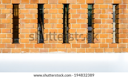 House brick wall with space between posts