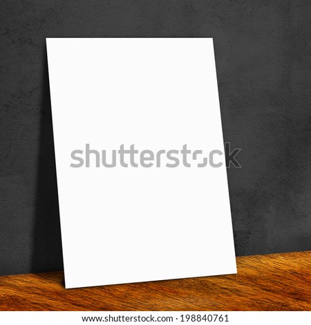 blank white paper on the black wall and the wooden floor,Mock up for your content
