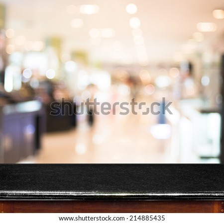 Empty black marble table and blur store in background. product display template.