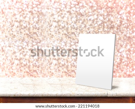 White paper frame at marble Table with bokeh pink sparkling background,Empty room for display your product