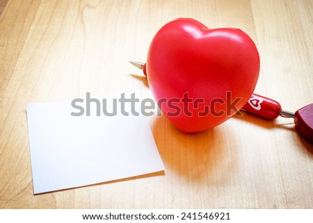 Vintage filter : Notepad with heart toy and red pen on wooden table,Template mock up for adding your content, love concept